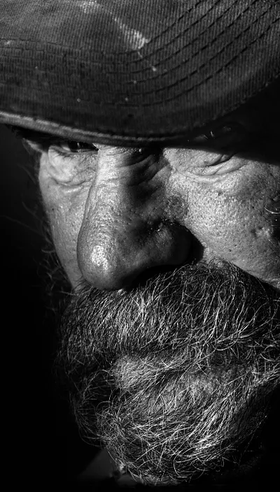 Black and white photo of an elderly bearded man.