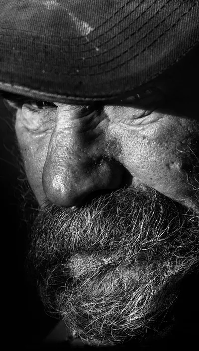Black and white photo of an elderly bearded man.