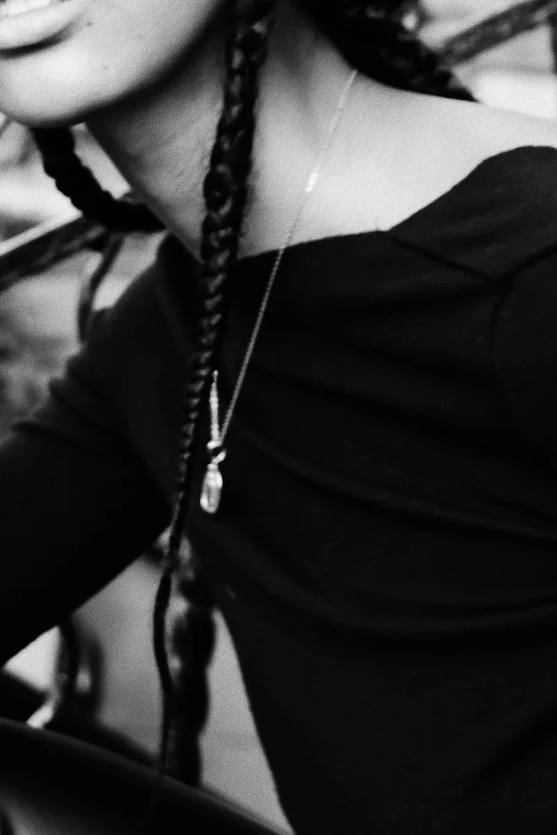 Black and white photo of a young girl sitting on a staircase.