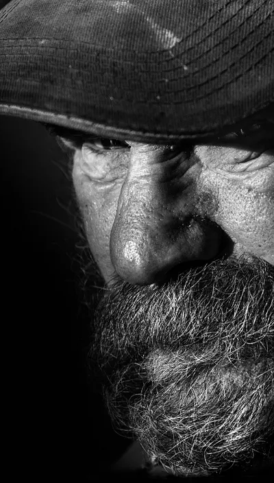 Black and white photo of an elderly bearded man.