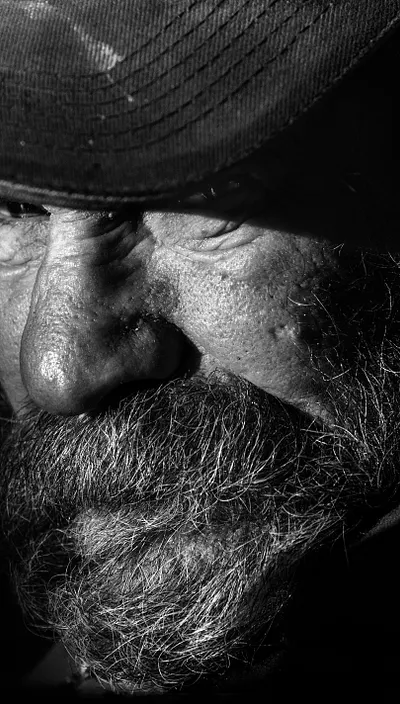 Black and white photo of an elderly bearded man.